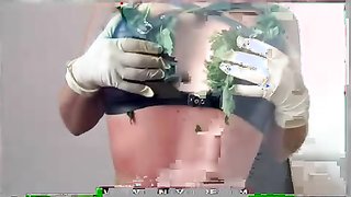 Slender babe in black stockings sticks nettle in her snatch