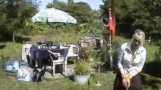 Submissive blonde is falling on the grass to bound herself