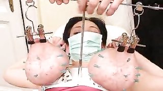 Dirty Doctor presses her tits and impales them with needles