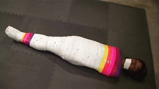 Slender young ebony is trying mummy-style bondage with polyethylene