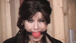 MILF with big natural tits bound and ball gagged in standing position