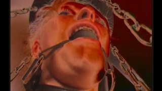 Mummified blonde in big latex boots is enjoying domination