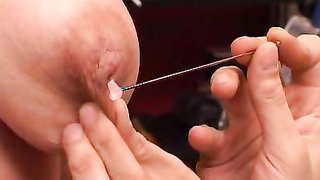 Redhead with natural saggy tits gets penetrated with spokes