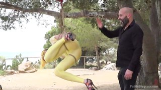 Public humiliation for a slave in white costume