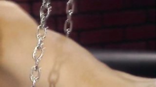 MILF Dominatrix plays with a chained fake-tit slave