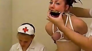 Nurse Dominatrix wraps her patient in the ward