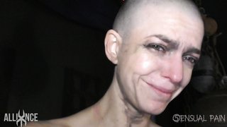 Bald young beauty with small natural tits is crying from pain