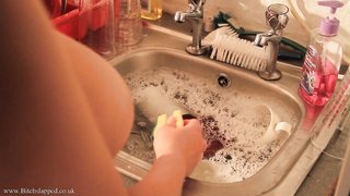 Busty chained chick is washing dishes while been fully naked