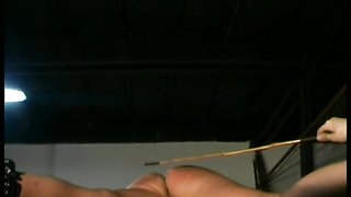 Chained girl hangs in the air during her first BDSM experience