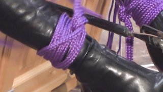 Glamorous big-boobed blonde bounds her legs with purple ropes