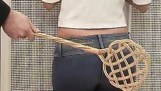 Young ass spanked with a carpet dust beater