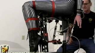 Mummified with a striped costume MILF sits on a mechanical dildo chair