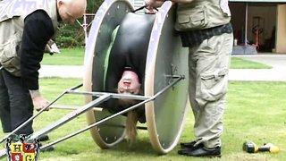 Slave bitch bent over a torture wheel and driven around the lawn