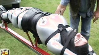 Submissive latex slut enjoys a ride while being unable to move