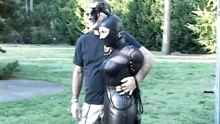 Master trains a busty slut in black latex body suit