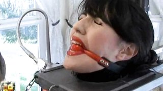 Young latex suit slave enjoys a hard machine fucking