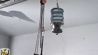 Submissive doll in red suit hangs right under the ceiling