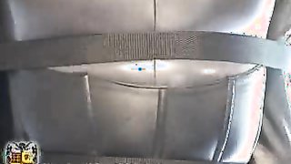 Gagged hottie in grey latex suit hangs upside down in front car