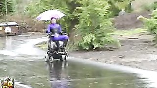 Sensual redhead beauty in purple suit uses her gf as a chair