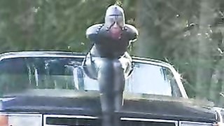 Latex whore attached and totally bound to a truck
