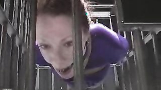 Gagged redhead suffers inside a metal cage, unable to move