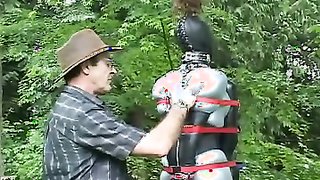 Bitch in latex forced to stand all day on high heels