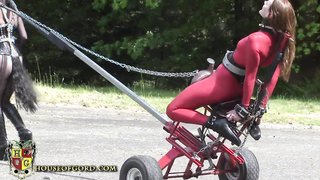 Busty brunette wheeling her "friend" as master taunts them